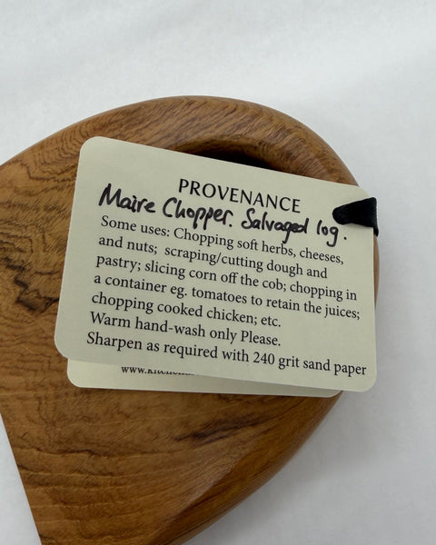 Product usage label on a wooden kitchen utensil.