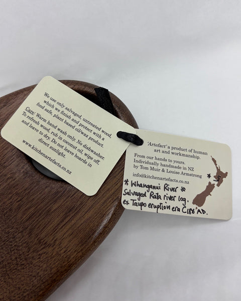 Product information tags for a wooden kitchen utensil.