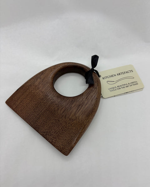 Wooden food chopper with a 'Kitchen Artefacts' tag