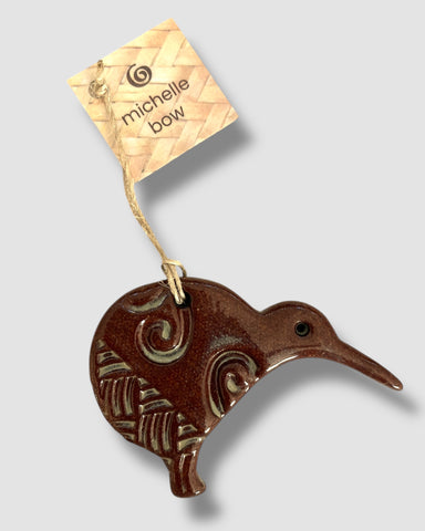 Handcrafted ceramic Kiwi decoration by Michelle Bow with stylised kowhaiwhai imprints in a brown glaze, with a woven brown cord.