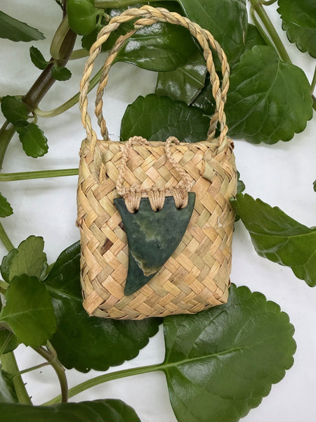 Greenstone Pendant with a bound natural cord on a woven flax bag
