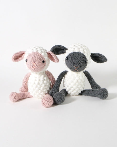 Two crocheted sheep soft toys 